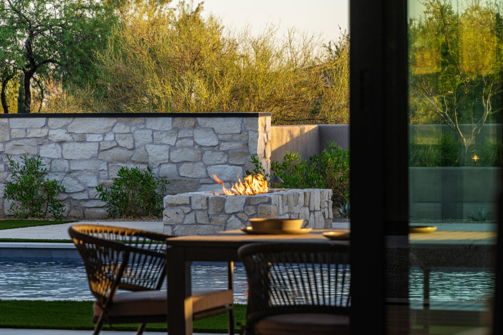 Cozy outdoor dining by a fire pit at sunset.